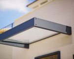 Sophia 2150 door canopy featuring a sleek gray aluminum frame and clear panels, enhancing outdoor entrance aesthetics and providing weather protection.